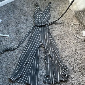 Gray and white striped jumpsuit with tie waist